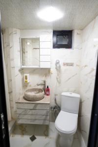 a small bathroom with a toilet and a sink at Ala's Old District in Kutaisi +40 photos