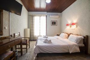 a bedroom with a large bed and a window at Hotel Villa Apollonia Delphi in Delphi +13 photos