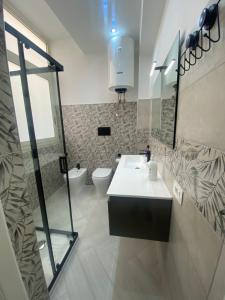 a bathroom with a sink and a toilet at OLYMPO HOUSE senza balcone in Agrigento +19 photos