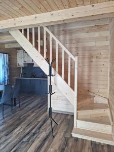a staircase in a room with a wooden wall at Góralska Przystań in Nowa Wieś
