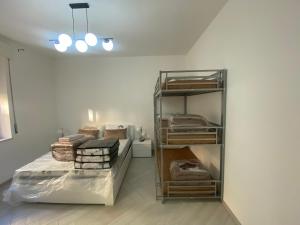 a room with a bed and a shelf with towels at OLYMPO HOUSE senza balcone in Agrigento