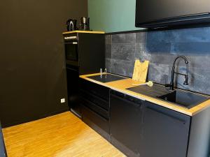a kitchen with a sink and a stove at Design Apartment in Plettenberg