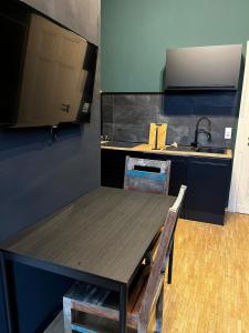 a kitchen with a wooden table and a sink at Design Apartment in Plettenberg