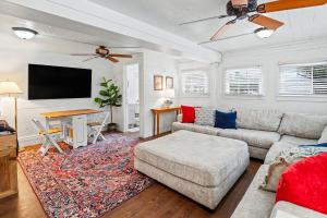 a living room with a couch and a flat screen tv at Beaufort 308 Charles in Beaufort