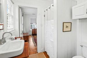a white bathroom with a sink and a toilet at Beaufort 308 Charles in Beaufort +28 photos