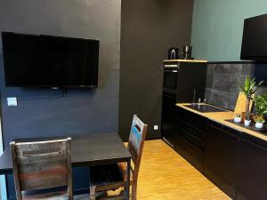 a kitchen with a table and a kitchen with a sink at Design Apartment in Plettenberg