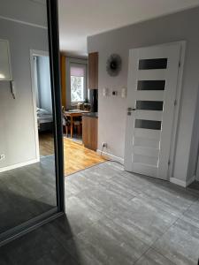 a room with a door and a living room at Apartament z widokiem 3 in Chełm