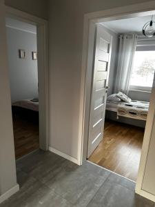 a room with a door leading to a bedroom at Apartament z widokiem 3 in Chełm