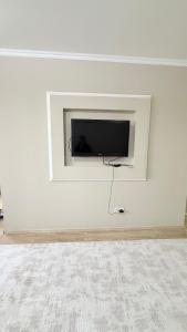 a white wall with a flat screen tv on a wall at ИП.МЕДИНА in Taraz