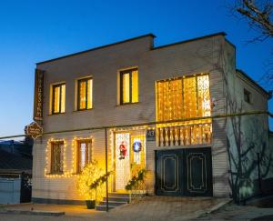 a house with christmas lights on the front of it at Ala's Old District in Kutaisi