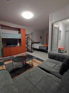 a living room with a couch and a bed at Laima in Riga