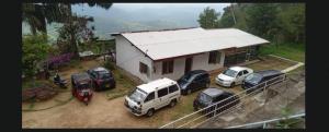 a group of cars parked in front of a house at Agape center in Haputale