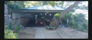 a building with a table and a bench in a yard at Agape center in Haputale