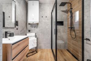 a bathroom with a sink and a shower at Domek Wierzbowa 5 in Brenna +25 photos