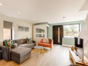a living room with a couch and a chair at 2 Bed in Alcester oc-88397 in Coughton