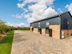 an external view of a building with a brick driveway at 2 Bed in Alcester oc-88397 in Coughton