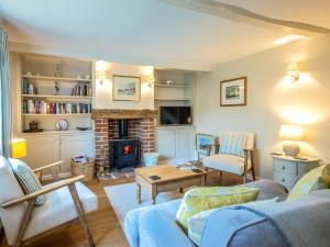 a living room with a couch and a fireplace at 2 Bed in Kelling Holt oc-76755 in Kelling