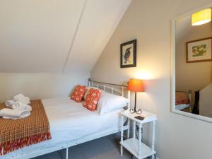 a bedroom with a bed and a mirror at 2 Bed in Kelling Holt oc-76755 in Kelling