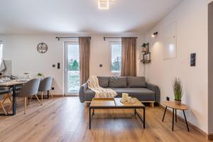 a living room with a couch and a table at Domek Wierzbowa 5 in Brenna