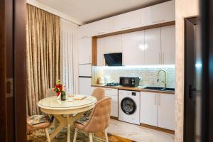 a small kitchen with a table and a sink at Ala's Old District in Kutaisi