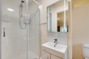 a white bathroom with a sink and a shower at 3 Bed in Machynlleth oc-bow306 in Darowen +10 photos