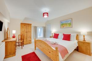 a bedroom with a large bed with red pillows at 3 Bed in Machynlleth oc-bow306 in Darowen