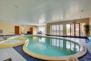 a large pool with a hot tub in a room at 2 Bed in Ingworth oc-1731 in Ingworth