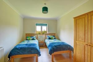 two beds in a small room with a window at 2 Bed in Ingworth oc-1731 in Ingworth +14 photos