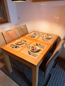 a wooden table with plates of food on it at Kuckucksnest in Ühlingen-Birkendorf