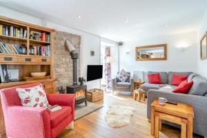 a living room with a couch and a fireplace at 2 Bed in Govilon oc-u32754 in Govilon