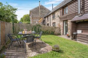 a patio with a table and chairs in a yard at 2 Bed in Govilon oc-u32754 in Govilon
