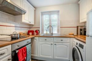 a kitchen with white cabinets and a sink at 2 Bed in Govilon oc-u32754 in Govilon +20 photos