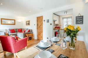 a living room with a table and a red chair at 2 Bed in Govilon oc-u32754 in Govilon