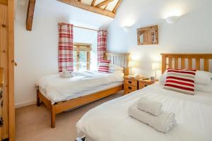 a bedroom with two beds and a window at 2 Bed in Govilon oc-u32754 in Govilon