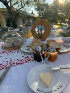 a table topped with plates of food and spoons at Casa Felicia Home in Bonifacio