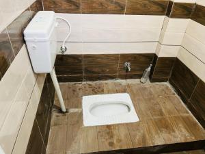 a dirty bathroom with a toilet in the floor at BNT BOYs HOSTEL in Lucknow