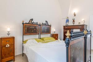 a bedroom with a large bed and wooden furniture at Dimora 1890 in Parabita