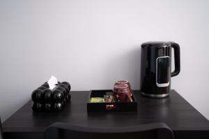 a black table with a coffee maker and a box at Hôtel Sofiane in Paris