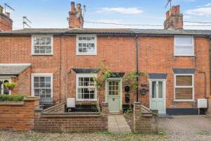 a red brick house with white windows and doors at 2 Bed in Beccles oc-d33611 in Beccles