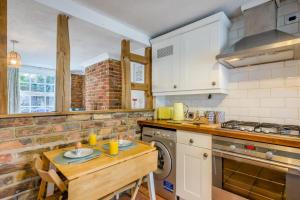 a kitchen with a wooden table and a stove at 2 Bed in Beccles oc-d33611 in Beccles +8 photos