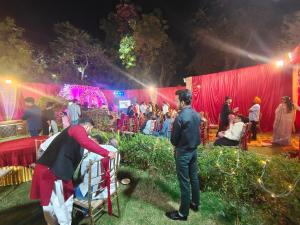 a group of people standing in front of a stage at Hotel Ravi Palace Agra in Agra