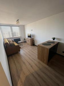 a living room with a couch and a table at CityView Tychy in Tychy