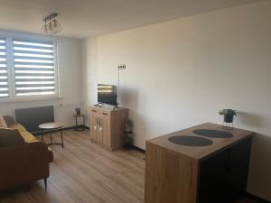 a living room with a couch and a table at CityView Tychy in Tychy