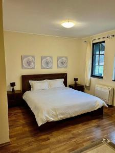 a bedroom with a large bed with white sheets at Къща за гости Геша Форест 3 in Dryanovo +22 photos