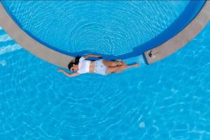 a woman is swimming in a swimming pool at Sevan Up In in Aghk'ilisa