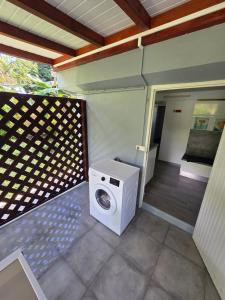 a washing machine sitting on the outside of a house at Gite thérèse LAMENTIN in Lamentin