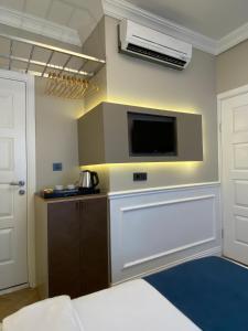 a room with a bed and a tv on a wall at Pera Standard Rooms in Istanbul +25 photos