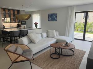 a living room with a white couch and a table at Villa Oasis Poreč in Labinci