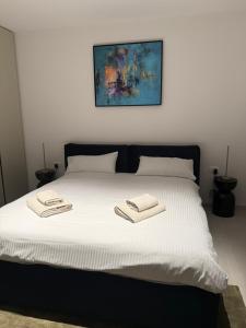 a bed with two towels on top of it at Villa Oasis Poreč in Labinci +31 photos
