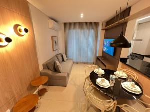 a small living room with a table and a couch at LK Savassi 7 in Belo Horizonte